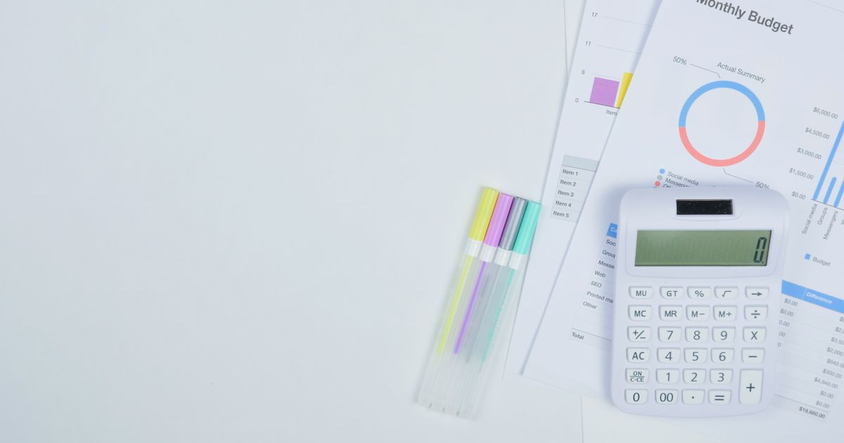 Budget planning documents with a calculator and pens