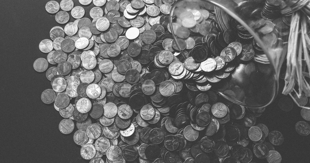 Coins spilling from a glass jar
