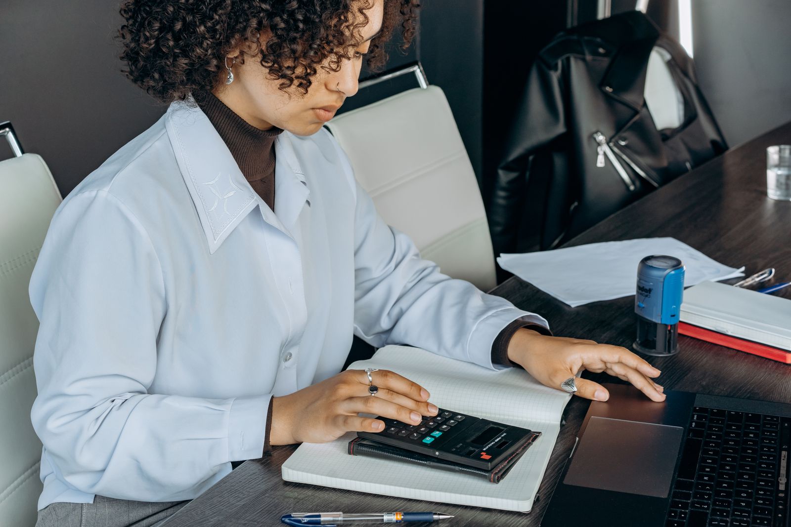 Photograph of a school administrator working out a fee payment plan with a calculator