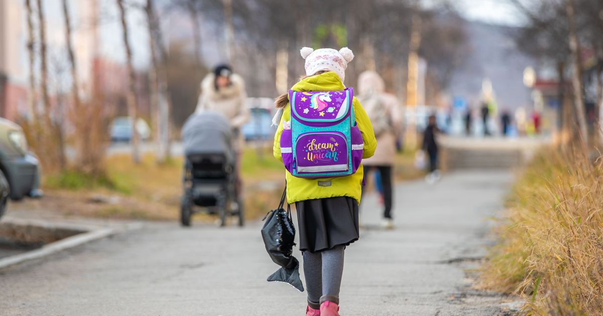 Child walking to school with a backpack for the new school year