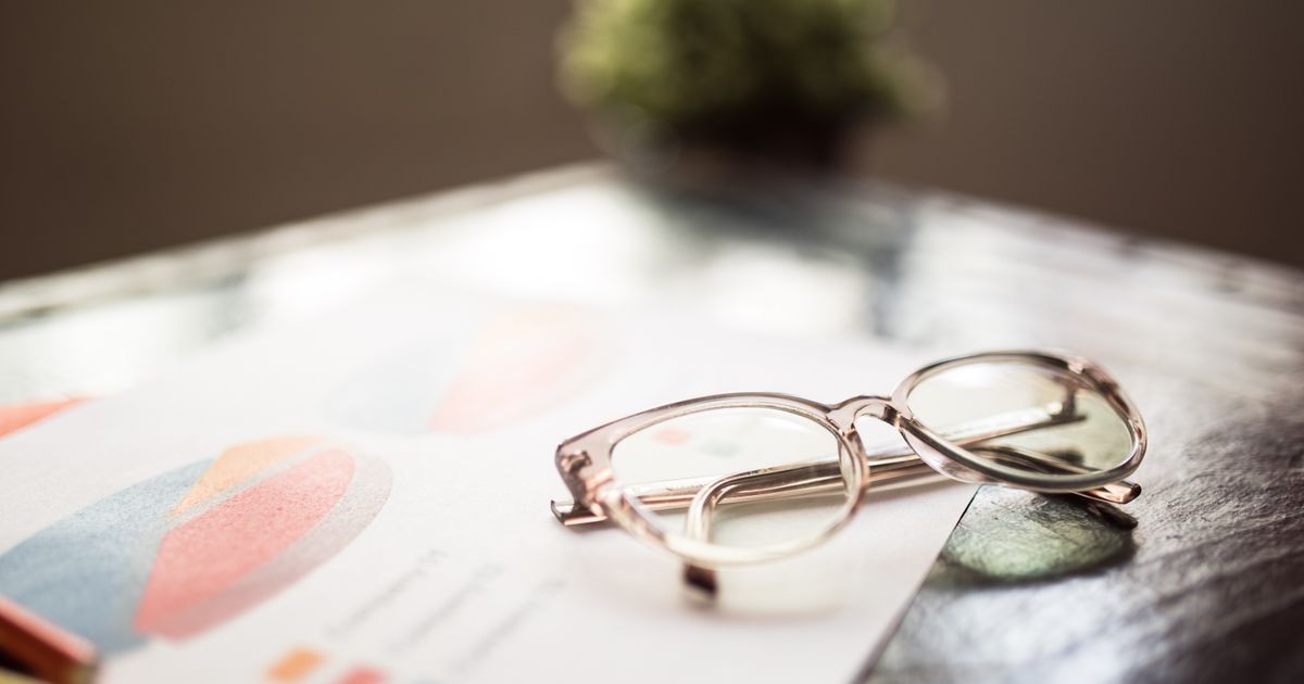 Financial documents and charts being reviewed on a desk